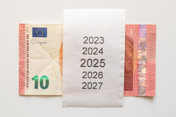 Ten euro banknote and check with years from 2023 to 2027 on white background, planning money