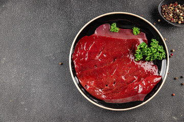 Raw liver beef veal meat steak liver grill appetizer vegetables dish fresh delicious gourmet food background on the table rustic food top view copy space keto and paleo diet