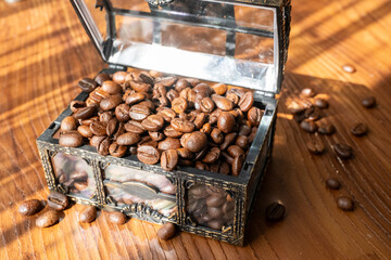 Coffee beans in glass treasure chest close up