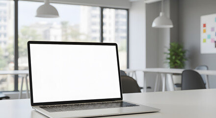Laptop mockup with blank screen in coworking space, natural light, modern tech environment