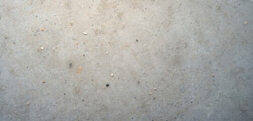 Naklejka premium Abstract cement floor texture background. Grey concrete surface with subtle details. Rough, grainy stone floor pattern with grit and small pebble details. Industrial construction material.