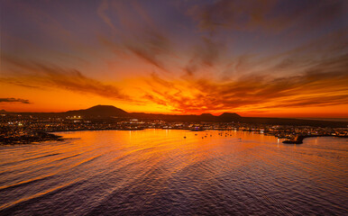 Spectacular aerial panoramic landscape image of the evening sunset sky at golden hour over the town of Corralejo, Fuerteventura, Canary Islands, Spain