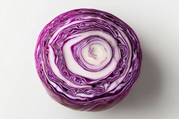 Obraz premium A vibrant close-up of a sliced red cabbage revealing its intricate layers and patterns, with a white background, highlighting the fresh vegetable's natural beauty.