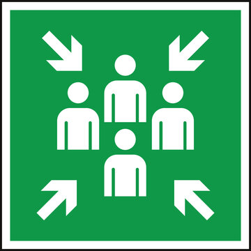 Green assembly point sign indicating a safe gathering area for individuals during emergencies