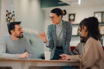 Creative business team brainstorming during meeting in modern office