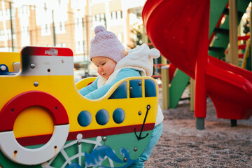Young Child Exploring Vibrant Playground Structures During Afternoon Playtime in a Colorful Outdoor Setting