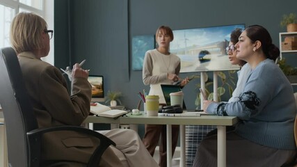 Group of diverse businesswomen discussing wind and solar energy presentation during in team meeting in office - Powered by Adobe