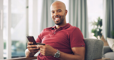Portrait, black man and smartphone with credit card in home, password information and online shopping. Sofa, happy person and mobile with debit for ecommerce, payment and subscription for application