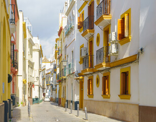 Charming narrow street in Old Town Seville, Spain.