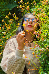 A woman beautifully immersed among vibrant wildflowers in the serene embrace of nature