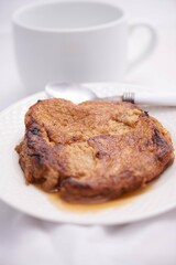 Toronjas - sweet wine-soaked bread with raisins, a traditional Easter Week dish from El Salvador on white tableware.