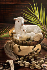 Easter card with lambs in metal bowl on wooden table