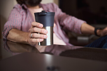 Young Man Relaxing with a Coffee Mug in a Casual Environment