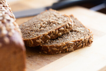 Fresh Slices of Whole Grain Bread on Wooden Cutting Board