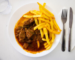 National French dish is Beef bourguignon, made from appetizing beef with wine, carrots, onions, mushrooms and served..with French fries