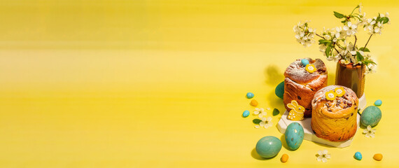 Easter cake Cruffin or sweet bread kulich. Traditional festive baking and blooming cherry branches
