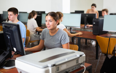 Portrait of young female student studying in university computer class