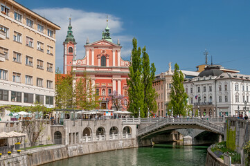 Franciscan Church of the Annunciation and buildings along the promenade of the navigable Ljubljanica river in the city center of Ljubljana, Slovenia.