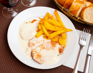 Tasty french style meat with side dish of fried potato closeup