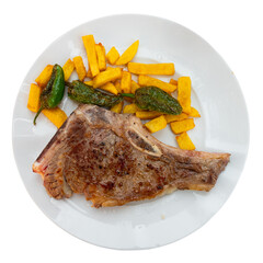 Tasty juicy entrecote of beef sirloin served with baked green pepper and potatoes. Isolated over white background