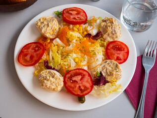 Deviled eggs with canned tuna and a salad, traditional spanish dish