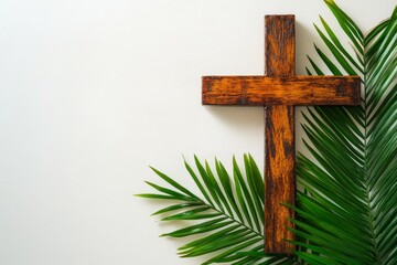 The image of a simple wooden cross with a palm frond on a white background is perfect for religious themes