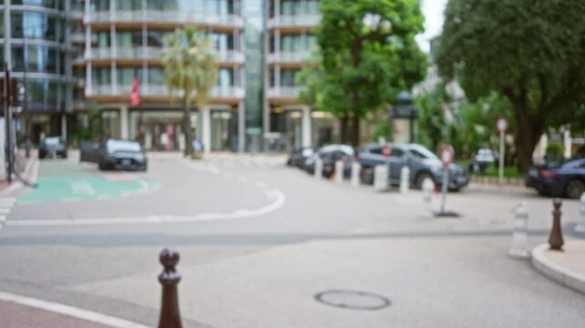 Blurred street scene in monaco shows luxury cars parked along an elegant boulevard lined with palm trees and modern architecture in a relaxed, upscale environment.
