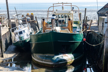 Obraz premium Fishing boats at low tide time in Oosterschelde, Zeeuwse oysters village Yerseke, Zeeland, The Netherlands