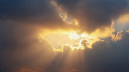 Fototapeta premium Lovely sunset through the clouds, creating a stunning ray of light