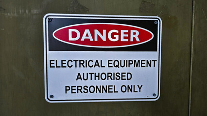 Warning sign indicating restricted access to electrical equipment for authorized personnel only near a facility