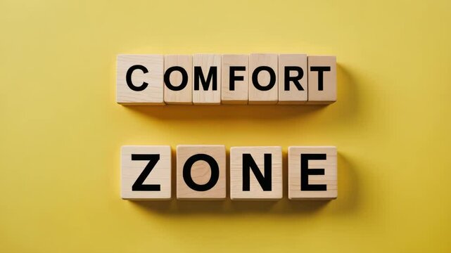Message about comfort zone displayed on wooden blocks in the background.