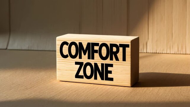 Message about comfort zone on wooden block with cardboard backdrop. Conceptual representation. Empty space.