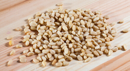 Photo of mix pine nut on the wooden desk, nobody..