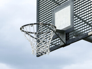 Outdoor basketball hoop on overcast day