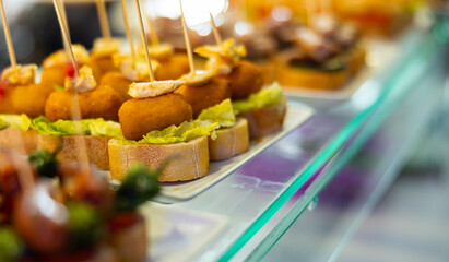 Pincho con croquetas - traditional Spanish snack or bar snack. Ham croquette and a piece of baguette