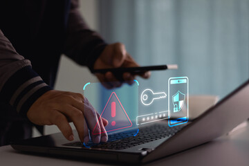 Cyber crime and cyber security alert warning concept. Hand using laptop and smartphone with 2 step...