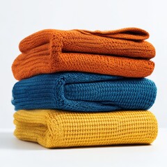 Stack of folded colorful knitted sweaters