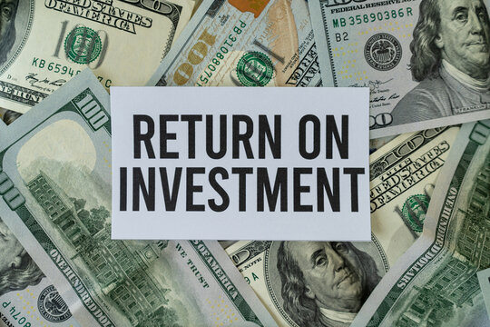 Sign that says "Return on investment" on cash dollar bills. Concept of good investments and making great returns.