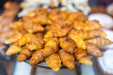 Close-up of showcase, store sells its own baked goods, puff pastry. Croissants, rolls with cheese and chocolate filling