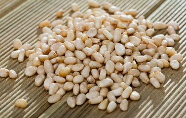 Picture of wooden desk with raw pine nut, no people