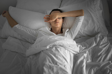 Woman waking up tired having bad night sleep 