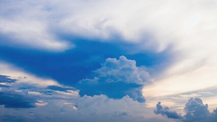 The sky is blue with a few clouds scattered throughout. The clouds are white and fluffy, giving the sky a peaceful and serene appearance