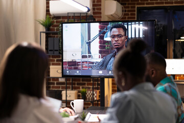 African american remote colleague participates in brainstorming session for business strategy. Online collaboration session with diverse team strategizing and sharing financial project plans.