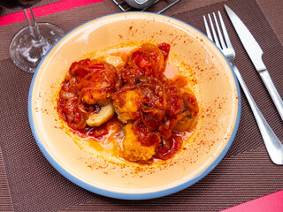 Hearty lunch, cooked xanfaina cod with seasonal vegetables on porcelain plate. Healthy food, Mediterranean diet