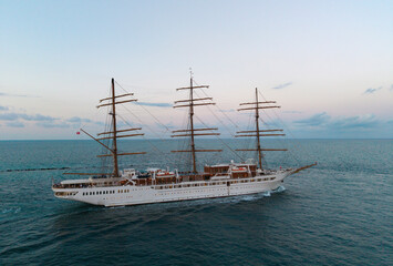Sail training ship. Sailing boat at dramatic sky seascape. Ship sailing the sea. Sail oat at port of Miami. Travel by sea. Seascape horizon at sunset. Sea vacation. Sailboat vessel