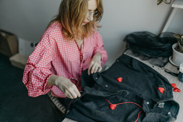 Woman making a decoration with hearts on shirt