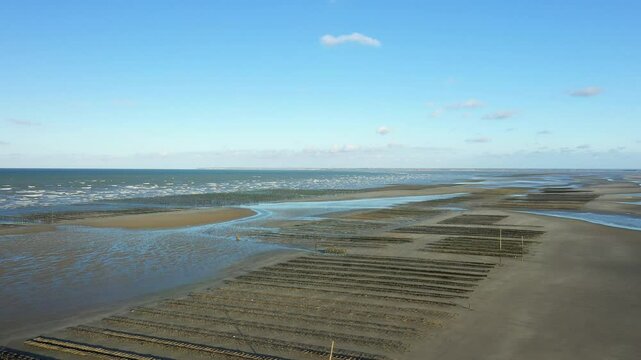 The long stretch of sand and oyster beds of Utah Beach in Europe, France, Normandy, near Carentan, in spring, on a sunny day.&nbsp;
