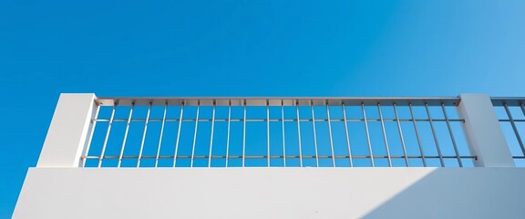 Sleek, geometric balcony railing against a vibrant blue sky; ample negative space,  metalwork, modern architecture