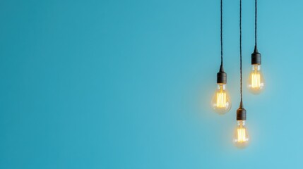 Three glowing bulbs hang against blue wall; idea concept; website banner
