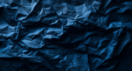 Fototapeta premium a dark blue background with the texture of crumpled paper